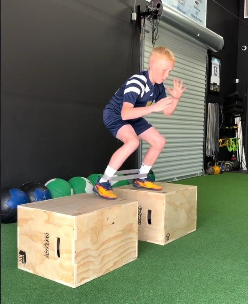 Young athlete performing a banded box jump at the T4P facility